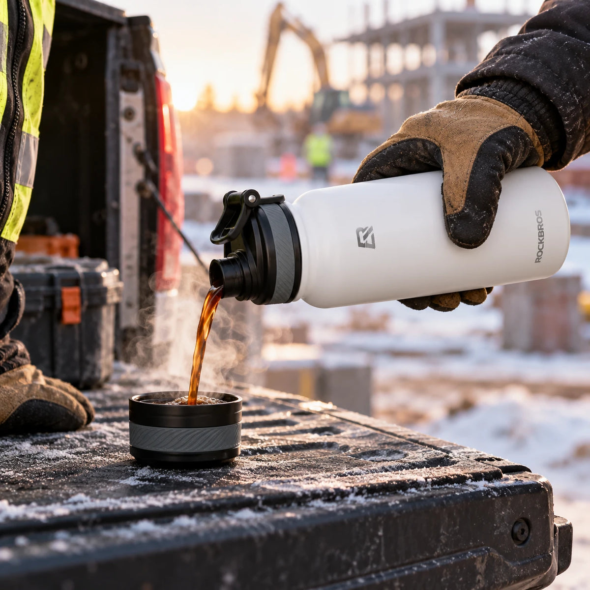 Pouring hot coffee from the white work flask on a tailgate