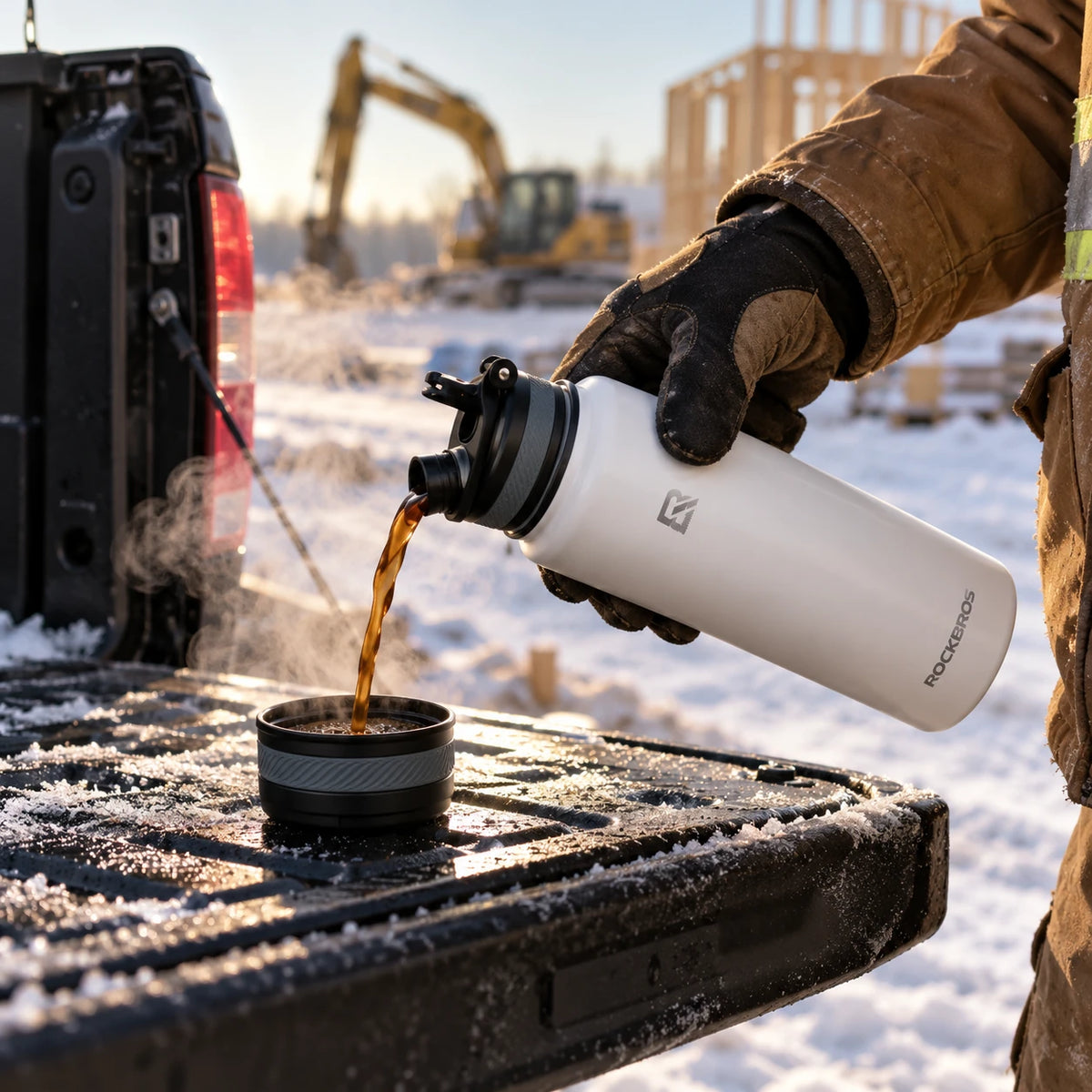White work flask pouring coffee on a cold job site